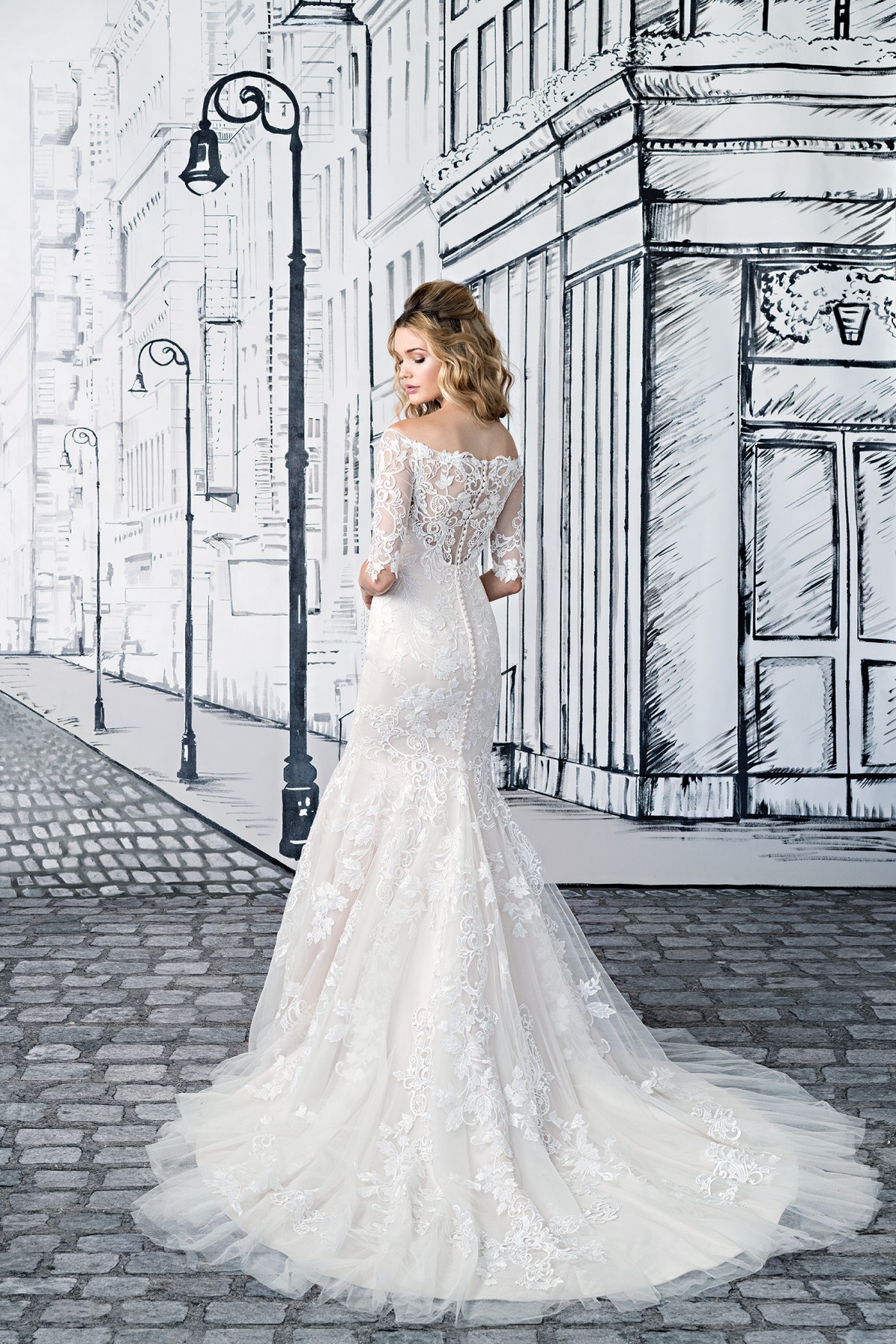 Ivy - Size 12 - Justin Alexander 8903, Off the shoulder lace Mermaid wedding dress with elbow length lace sleeves available at Blessings Bridal Boutique, Brighton, East Sussex, BN1 5GG. Telephone: 01273 505766