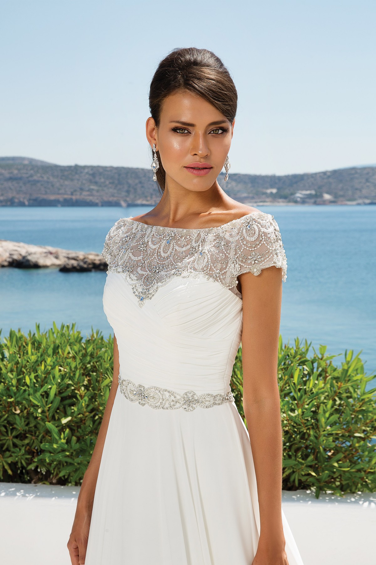 8799 - Aphrodite - Justin Alexander 8799, Chiffon Grecian Style A-line Wedding Dress with Beaded Off the Shoulder Neckline available at Blessings Bridal Boutique, Brighton, East Sussex, BN1 5GG. Telephone: 01273 505766