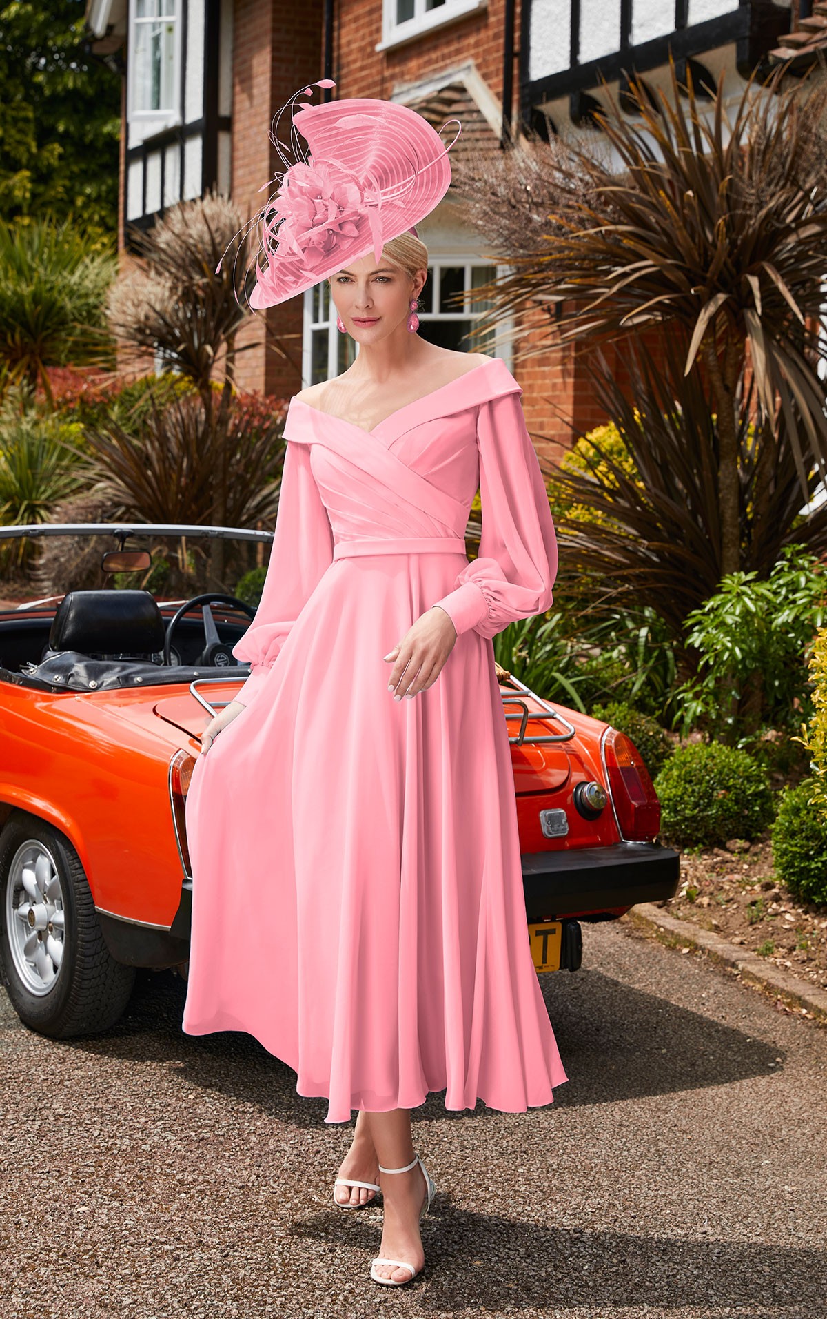 Veni Infantino - 29677 Size 10 - Veni Infantino 29677 - Coral Chiffon dress with Off the shoulder neckline & sleeves Mother of the Bride & groom dresses Now on Sale at Occasions at Blessings Loyal Parade, Mill Rise, Westdene, Brighton. BN1 5GG T: 01273 505766 E: info@blessingsbridal.co.uk