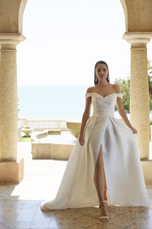 Veni Infantino for Ronald Joyce - Yoneko - Mikado A-line off the shoulder wedding dress with skirt slit at Blessings Of Brighton, Westdene, Brighton.E.Sussex Bn1 5GG T: 01273 505766