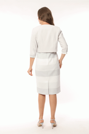 Woman in a white Lizabella 2583 dress and jacket with her back turned, standing in a white studio, wearing heels.