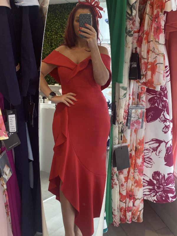 Dressed in the elegant Frank Lyman 229321, person captures a stylish mirror selfie at a clothing store.