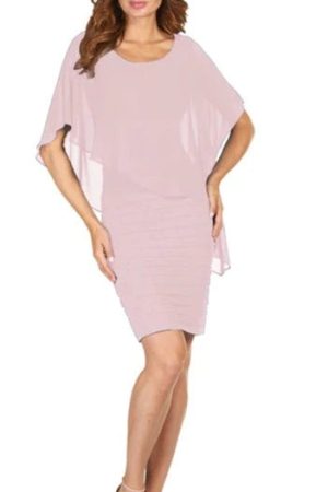 A woman gracefully poses against a plain white backdrop, showcasing the Frank Lyman - 51027, a light pink short-sleeve dress with an elegant layered design.