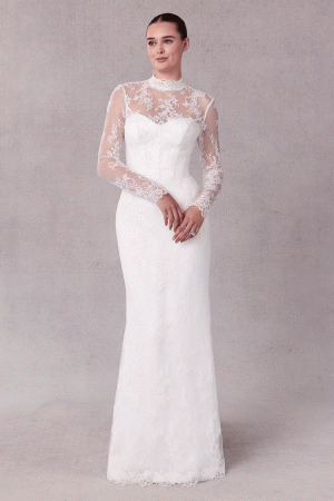 A bride in a Mori Lee 15102 - Sibhon lace wedding dress with sheer long sleeves stands gracefully against a neutral background.