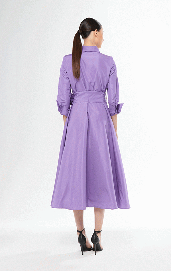 Dressed in the Carla Ruiz - 51547 purple trench coat and high heels, the figure exudes elegance, standing confidently against a pristine white background.