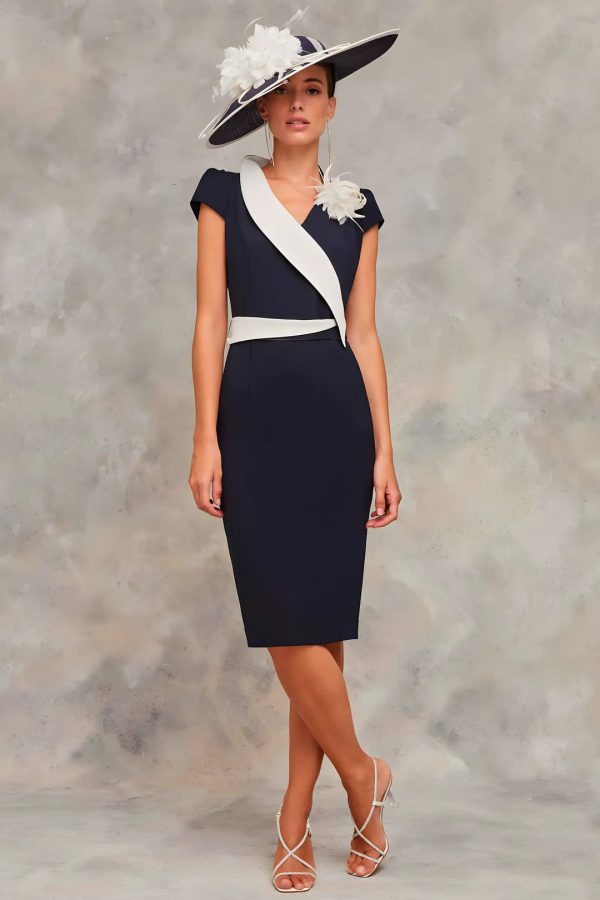 Claudia Civit captivates in the elegant navy Dali dress, paired with a large hat and floral accents, perfect for a timeless statement against any neutral backdrop. Available exclusively online.