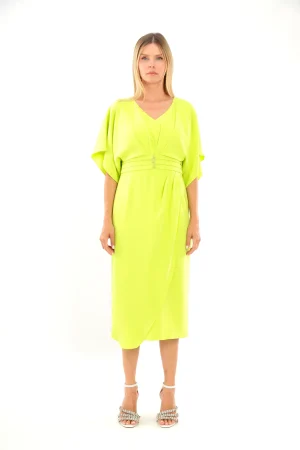 Woman wearing the Lizabella - 2044 midi dress in bright yellow-green with loose sleeves, standing against a white background.